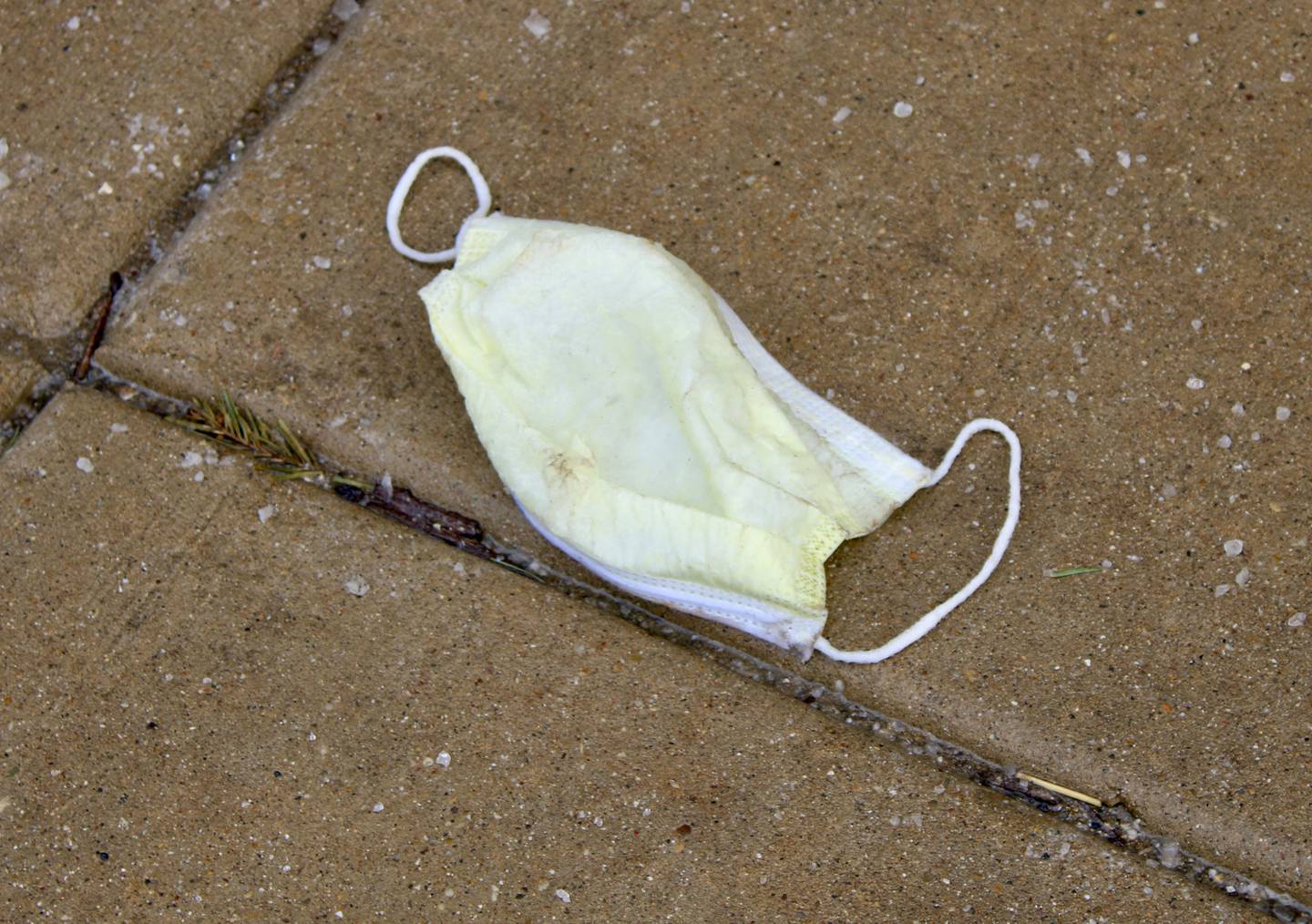A face mask lays discarded Wednesday on the sidewalk outside Town Square Centre on First Street in Dixon, the same day that Gov. JB Pritzker announced he would provisionally lift the masking mandate for the state on Feb. 28.