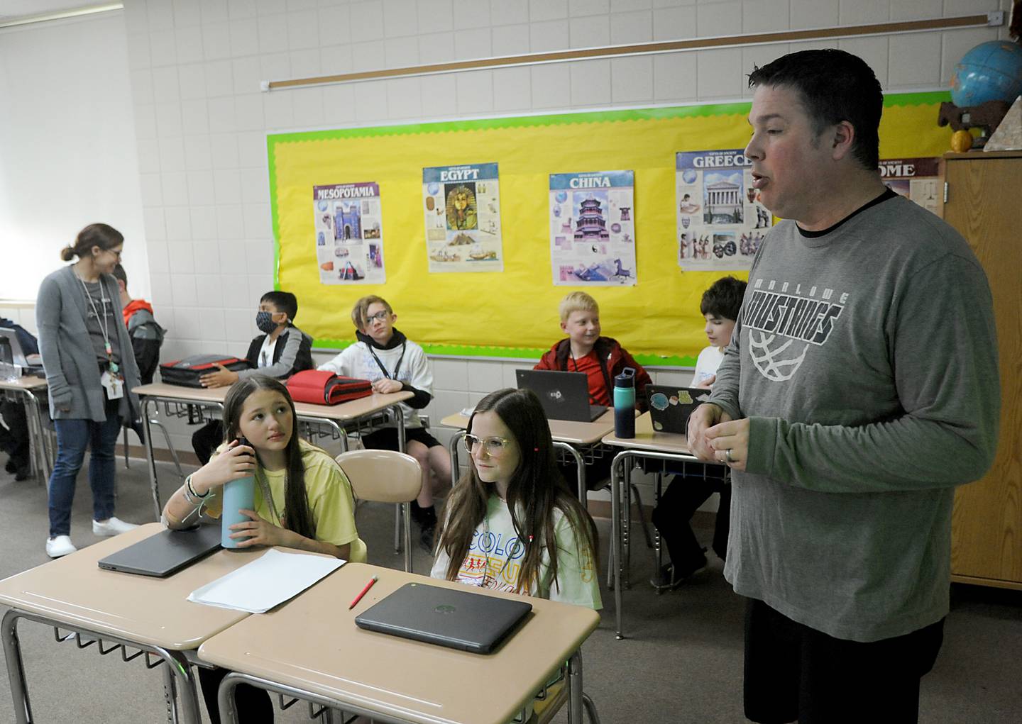 Teachers Ryan Starnes and Amy Ehmen, in background, talk to students Friday, April 29, 2022, as he teaches his social studies class at Marlowe Middle School. Several Huntley School District 158, classes have raised money for philanthropy causes.