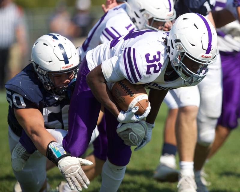 Cary Grove's Ty Drayton tackles Hampshire's Tymere on Saturday Oct. 5,2024 in Cary.