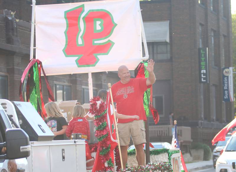 La Salle mayor Jeff Grove waves march during the L-P homecoming parade on Thuesday, Oct. 2, 2025 downtown Peru.
