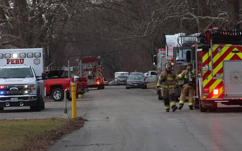 Firefighters gather at the entrance of the Starved Rock Lock and Dam on Tuesday, Jan. 13, 2026 near Utica. A light haze was coming from inside the Peru Hydroelectric Power Plant.  Fire departments from Tonica, La Salle, Wallace, Tonica, Peru and Utica all responded to the scene. The incident happened shortly before 2:30p.m. No injuries were reported.