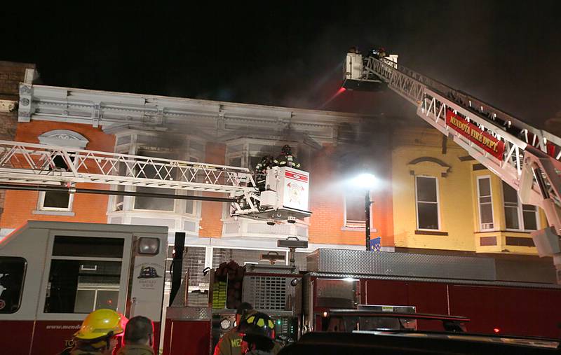 Mendota and Peru firefighters use aerial ladder trucks to spray down flames at 708 Illinois Avenue on Friday, Dec. 30, 2022 downtown Mendota.