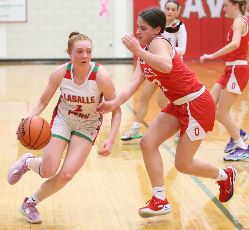 L-P's Addiosn Dutlinger runs around Ottawa's Marlie Orlandi to advance the ball closer to the hoop on Friday, Jan. 27, 2023 at L-P High School.
