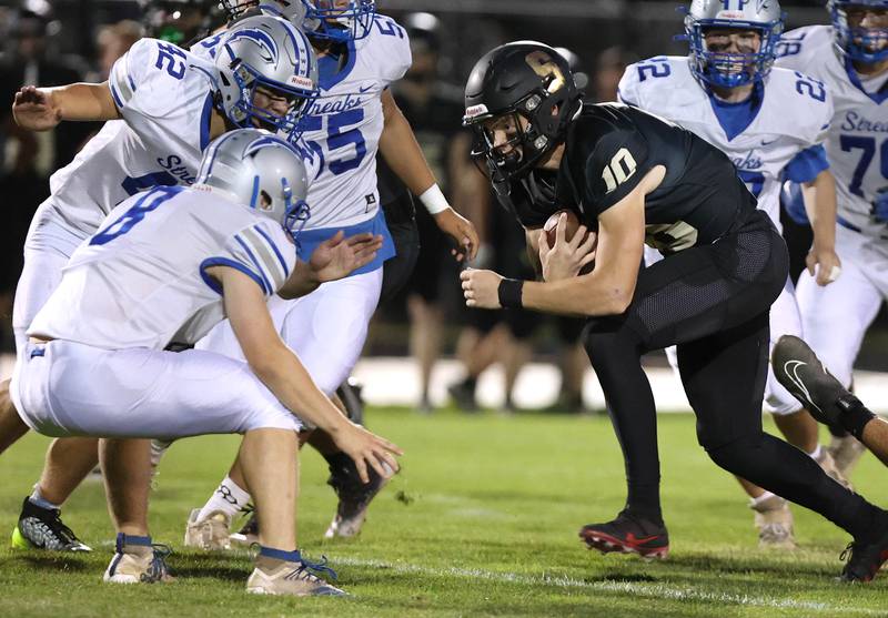Sycamore's Burke Gautcher looks to run through Woodstock's J.D. Canty during their game Friday, Sept. 8, 2023, at Sycamore High School.
