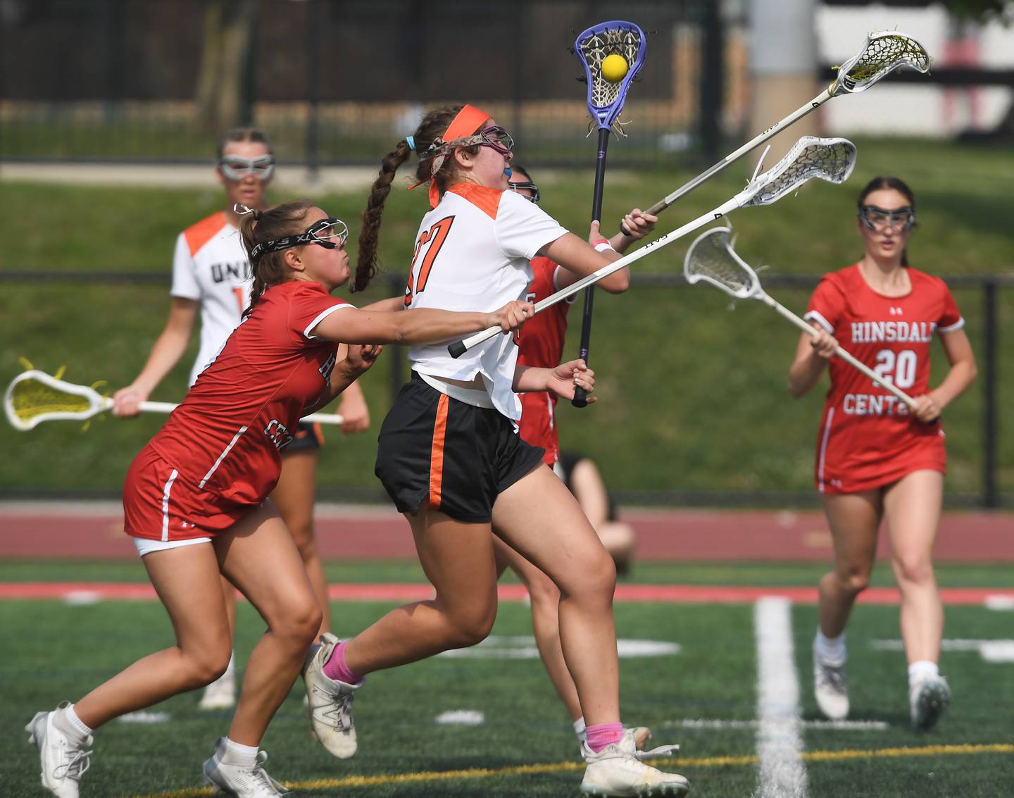 Crystal Lake Central Coop’s Anna Starr, right, makes a move past Hinsdale Central’s Wilhelmina Braden to score a goal during the third-place game of the girls lacrosse state finals at Hinsdale Central High School on Saturday, June 7, 2025.