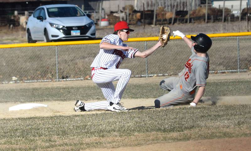 Forreston's Brady Gill gets ready to tag out a Warren/Stockton player at second on a good throw by catcher Mikey Prost on Friday, March 28, 2025 in Forreston. The Cardinals won the game 13-3.