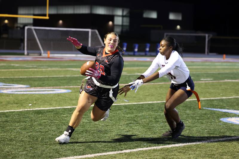 Yorkville's Kayla Kersting tries to evade Oswego's Jazmin Hurston during the Foxes' 2-1 overtime victory over Oswego in the IHSA Kankakee Regional championship game on Thursday, Oct. 9, 2025.