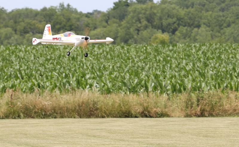 A model airplane flies over a cornfield on Monday, July 1, 2024 at the Model Airplane Field in Matthiessen State Park.  The Deer Park RC Flyers radio-controlled aircraft club maintains the model airplane field and flies model airplanes at the site.