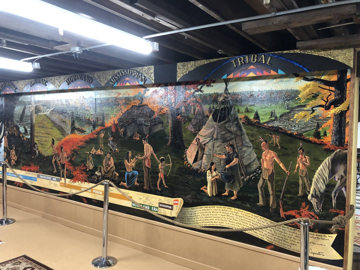 A mural depicting Native Americans on a timeline through the ages done by local artist Quen Carpenter on display at the Stone Mill Museum.