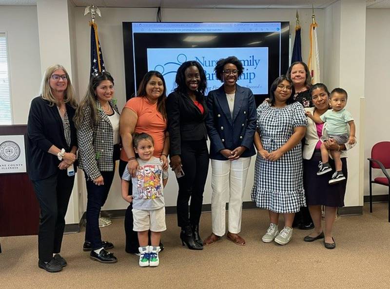 U.S. Rep. Lauren Underwood poses with Kane County Health Department staff, Nurse-Family Partnership National Service Office staff, Kane Kares program participants, public nurses and other staff  during her visit to the Kane County Health Department on Wednesday, Aug. 14.