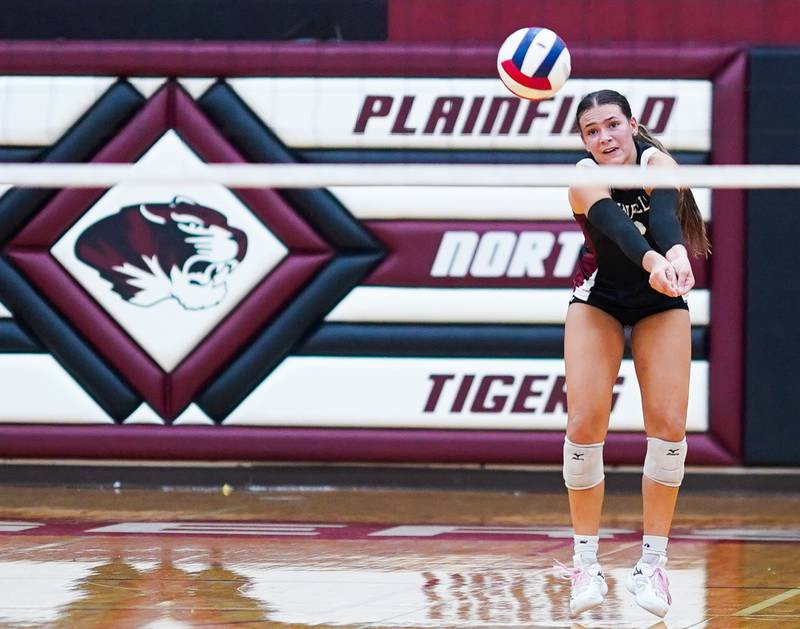 Plainfield North's Cassidy Clinton (23) bump sets the ball against Oswego during the class 4A Plainfield North regional volleyball final at Plainfield North High School on Thursday, Oct. 26, 2023.