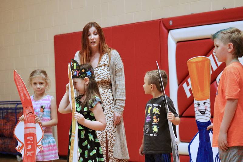 East Coloma Nelson School students Annabelle Palumbo, Willow Reick, Caleb Metzger and Jacek Anderson take on the roles of markers as author Amanda Fox leads them through the story of "Markertown" during a presentation on Friday.