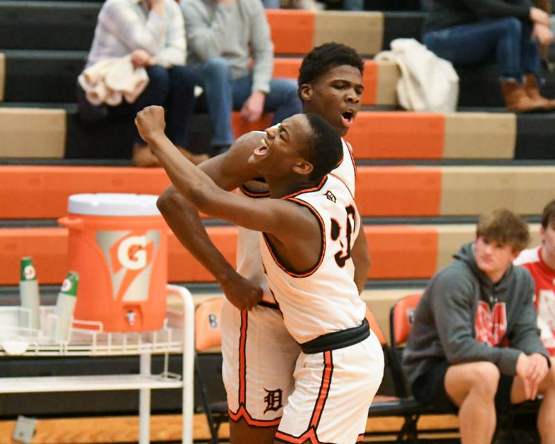 DeKalb's Billy Miller (30) celebrates with teammate Davon Grant after making a basket while being fouled by Naperville Central’s Alex Liabo during the first quarter on Friday Feb. 9, 2024, held at DeKalb High School.