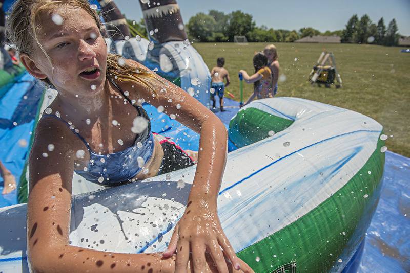 Mady Scully, 12, pops up out of the end of the slide after gathering a head of steam during Dixon Park District's SPARK camp June 16.