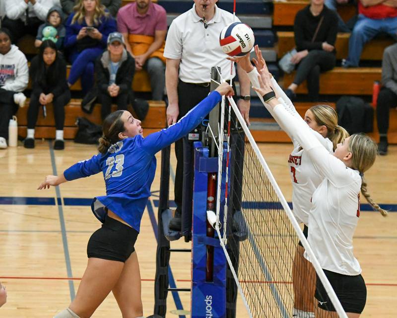Benet Academy teammates Audrey Asleson, center, and Lynney Tarnow, right, block the ball of St. Charles North's Haley Burgdorf (23) during the 4A sectional championship game held on Thrusday Nov. 7, 2024, held at West Aurora High School.