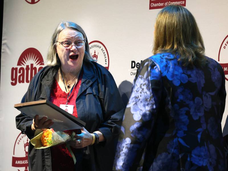 Donna Willrett (left) reacts after being presented her certificate for being a Woman of Accomplishment Honoree Thursday, Oct. 16, 2025, during the 35th annual Athena and Women of Accomplishment Award Reception at the Egyptian Theatre in DeKalb.