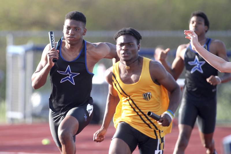 St. Charles North’s Joshua Duncan (left) runs the anchor leg of the 4x100-meter relay during the Class 3A St. Charles North Sectional on Thursday, May 19, 2022.