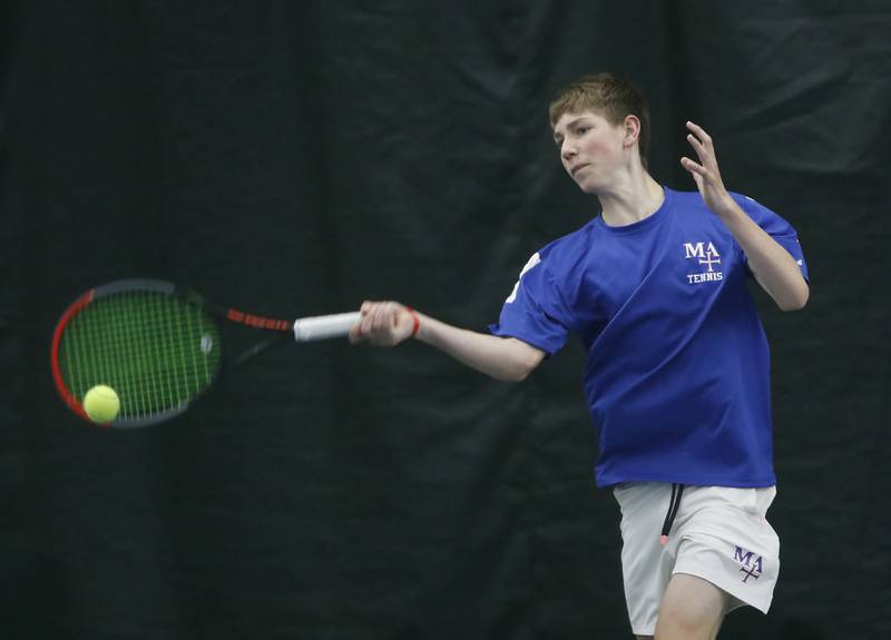 Marmion Academy’s Benedict Graft returns the ball during his IHSA 1A boys single tennis match against Woodstock North’s Jason Burg Thursday, May 26, 2022, at Heritage Tennis Club in Arlington Heights.