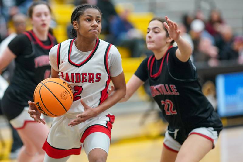 Bolingbrook's Kennedy Williams (2) plays the ball in the post against Yorkville's Sydney McCabe (22) during a Class 4A Metea Valley Regional final basketball game at Metea Valley High School in Aurora on Friday, Feb. 21, 2025.