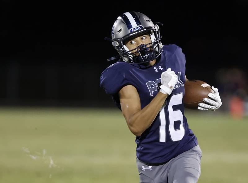 Oswego East's Donavin Eason (16) runs the ball during the varsity football game between Plainfield South and Oswego East on Friday, Sep. 20, 2024 in Oswego.