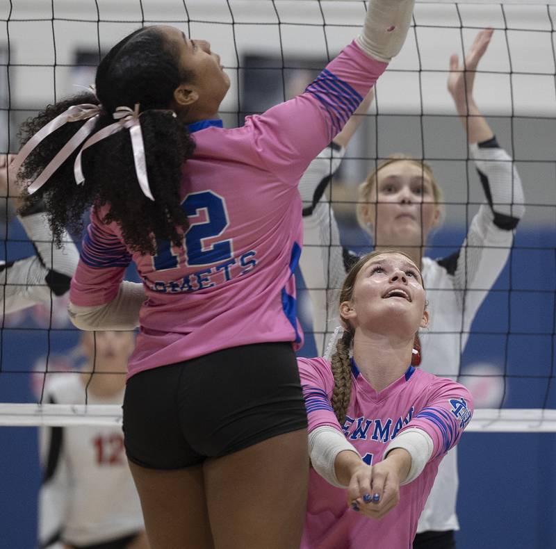 Newman’s Gisselle Martin (left) and Lauren McClain work for the ball against Erie-Prophetstown Tuesday, Oct. 14, 2025.