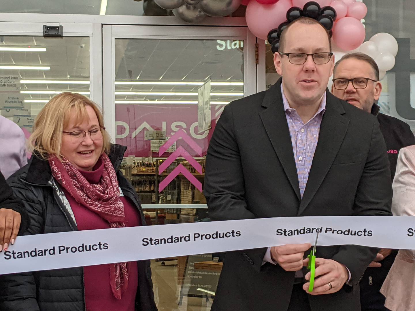 Oswego Village President Ryan Kauffman, right, and Oswego Village Trustee Karin McCarthy-Lange, left, help celebrate the Feb. 8 grand opening of the new Daiso store in Oswego. The store is the first Daiso store in the U.S. to carry the Standard Products line.