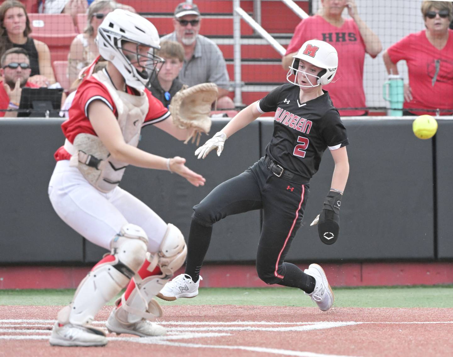 Mundelein’s Kieley Tomas comes in to score as Huntley catcher Madison Rozanski takes the throw in the IHSA Class 4A softball supersectional game at The Ballpark at Rosemont on Monday, June 3, 2024.