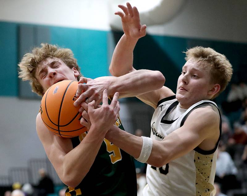 Crystal Lake South's Carson Trivellini battles with Sycamore's Isaiah Feuerbach during an IHSA Class 3A Woodstock North Sectional semifinal.basketball game on Wednesday, March 4, 2025, at Woodstock North High School.