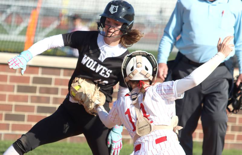 Huntley’s catcher Madison Rozanski, front, nabs Prairie Ridge’s baserunner Kylie Carroll for an out at home plate in varsity softball at Huntley High School in Huntley on Monday, May 5, 2025.