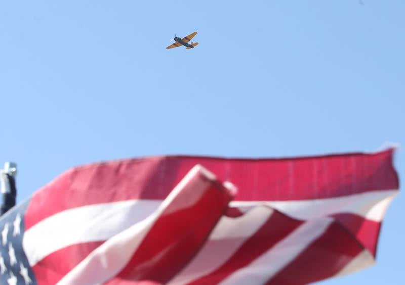 A TBM flys over an American Flag during the 10th annual TBM Avenger Reunion and Airshow on Friday, May 16, 2025 at the Illinois Valley Regional Airport in Peru.