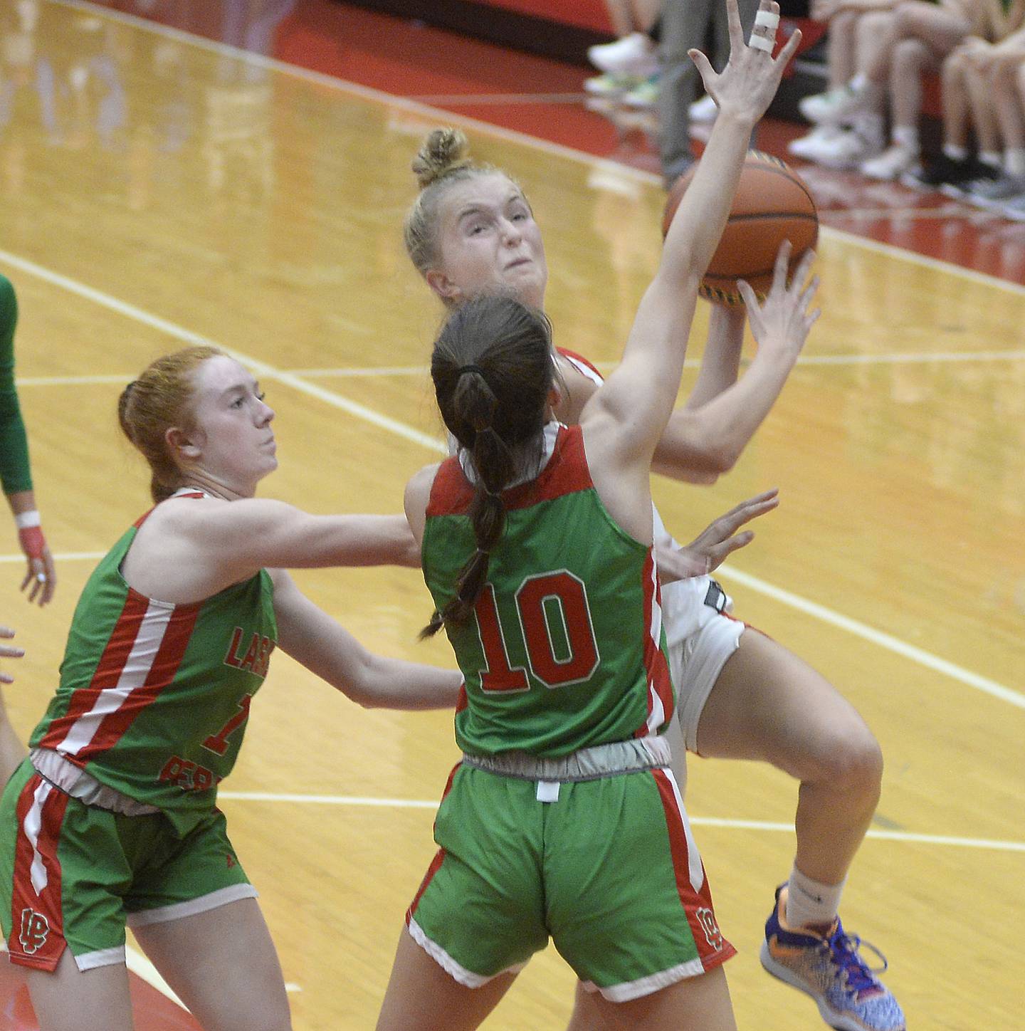 Ottawa’s Grace Carroll works to get up and over LaSalle Peru’s Addison Dutlinger and Bailey Pode in the 2nd period on Wednesday Dec. 7, 2022 at Kingman Gymnasium in Ottawa.