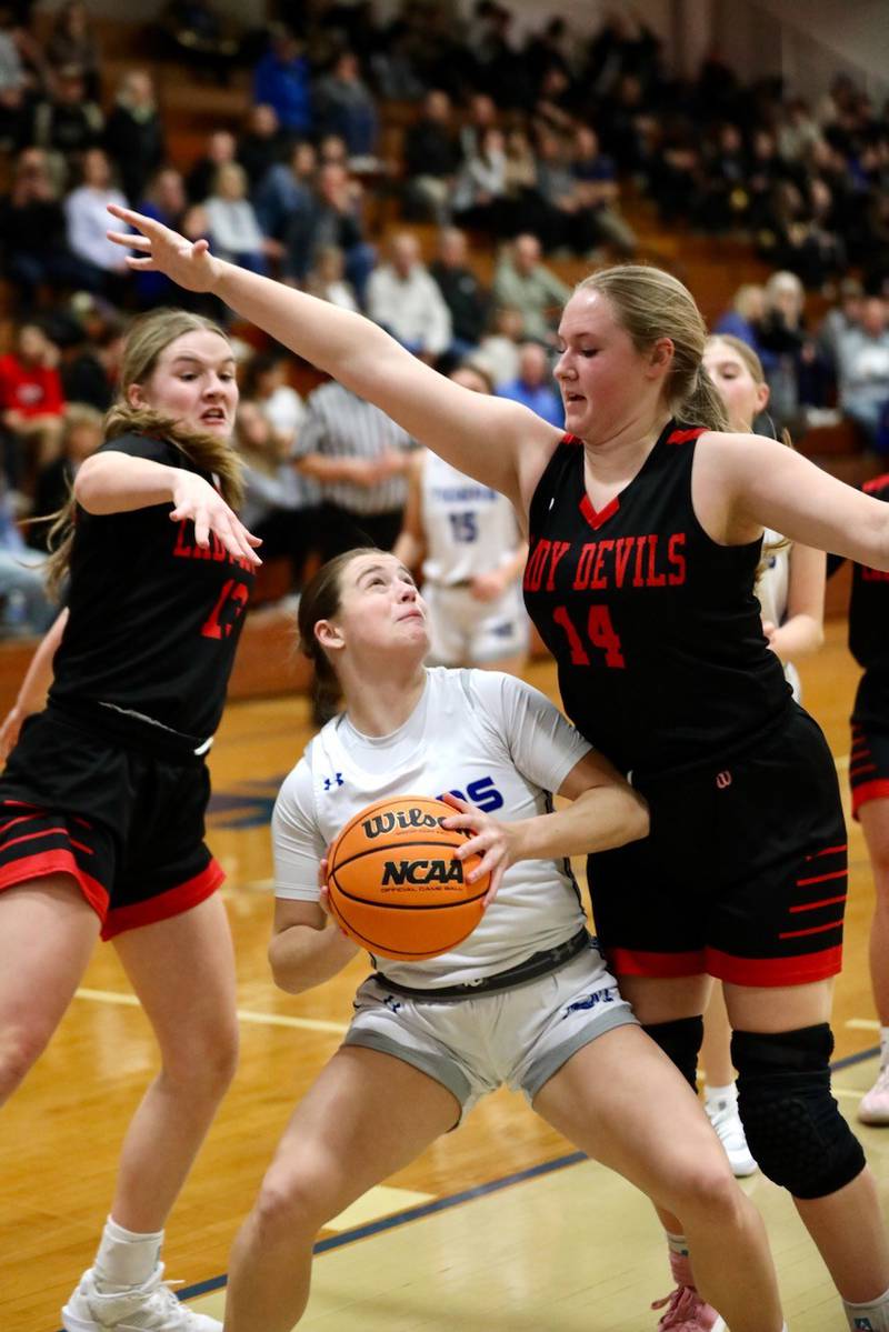 Princeton's Makayla Hecht tries to shoot amongst the trees of Hall defenders Caroline Morris (left) and Ella Sterling in Thursday's game at Prouty Gym. The Tigresses won 34-30.