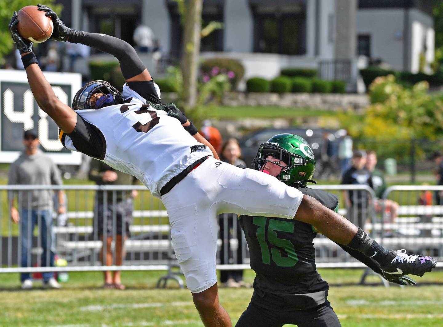 Joliet Catholic’s Jayden Armstrong (3) makes a touchdown catch in the end zone as Glenbard West’s Bryce Ellens defends during a game on September 6, 2025 at Glenbard West High School in Glen Ellyn.