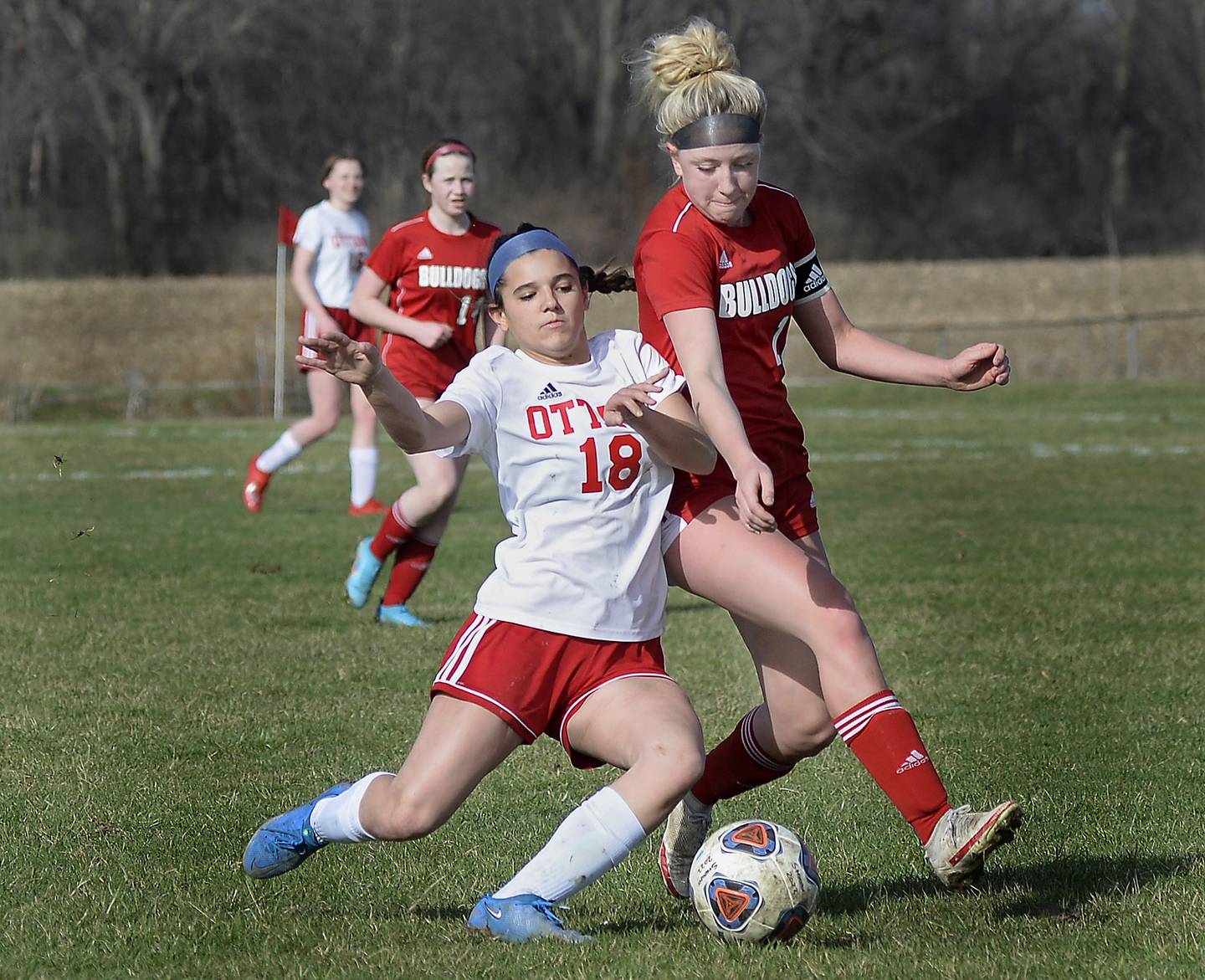 Ottawa’s Gabby Krueger (18 in white) and Streator’s Anna McMullen (18 in red) battle for possession Friday, April 1, 2022, during match at the Streator Family YMCA.