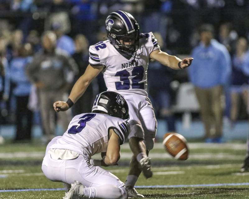 Downers Grove North's Baker Glomb (32) kicks an extra point during football game between Downers Grove North at Downers Grove South Friday, Sept 5, 2025  in Downers Grove.