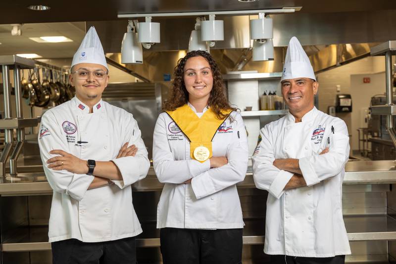 Caitlyn Drzyzga, 21, of Lockport (center) representing Joliet Junior College, earned first place in the Student Chef of the Year competition at the American Culinary Federation National Convention in July in New Orleans. Drzyzga is pictured with JJC culinary competition team coaches Chef Alexis Ramos (left) and Chef Paul Bringas (right).