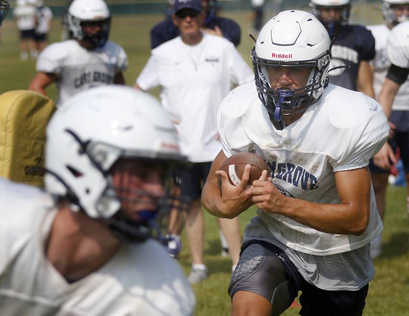 Cary-Grove’s Gavin Henriques runs with the football during football practice Thursday, June 29, 2022, at Cary-Grove High School in Cary.