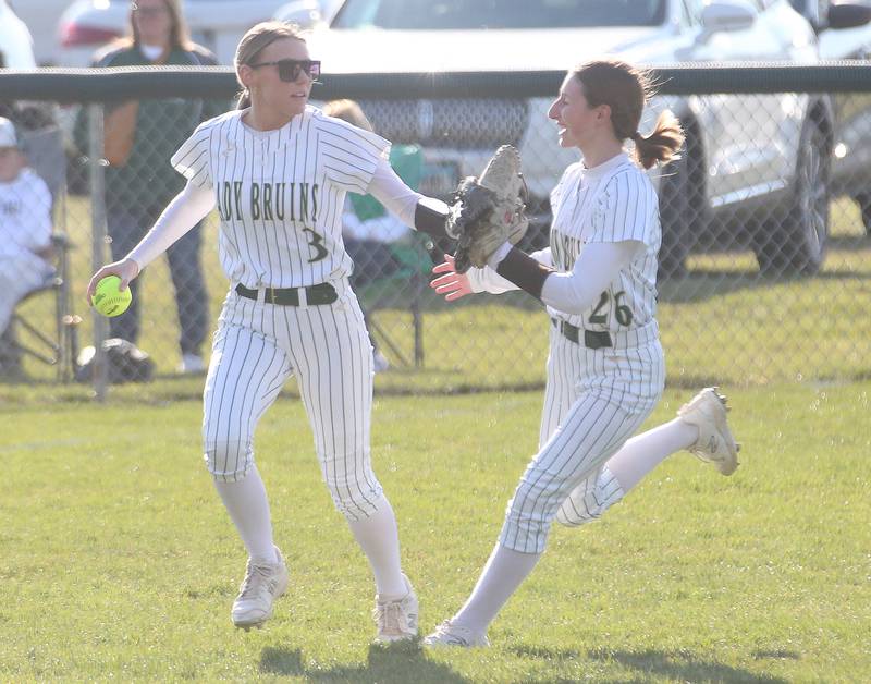 St. Bede's Macy Hartt hi-fives teammate Emma Slingsby while making the final out of the first inning against Midland on Thursday, March 21, 2024 at St. Bede Academy.