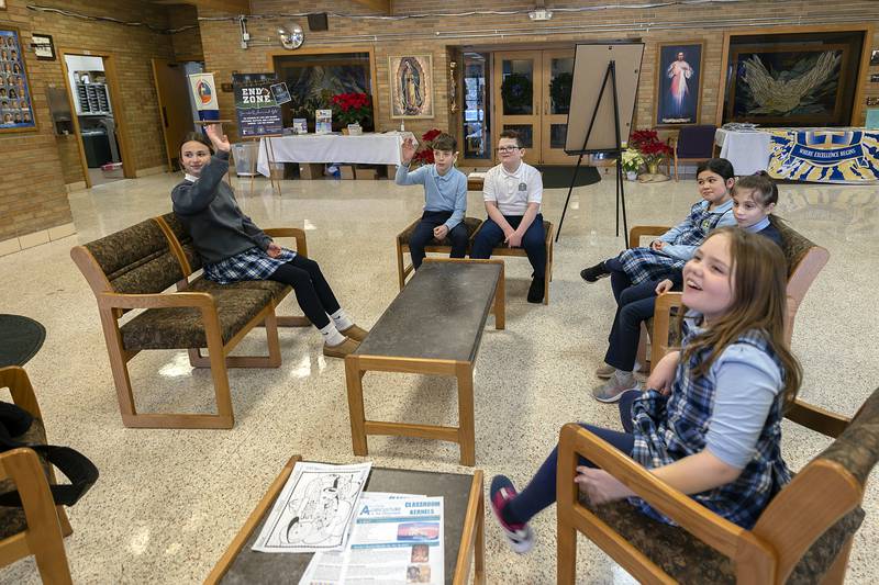 St. Anne’s students Raelie Bilharz (left), Drew Melendrez, Nolan Etheridge, Layla Welker, Klara Valdez and Chloe Furman answer questions on what books they will choose Wednesday, Jan. 22, 2025, when they’re able to use the book vending machine.