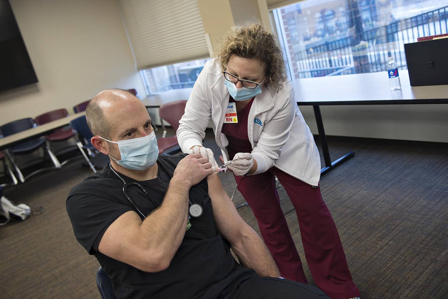 KSB respiratory therapist Jeremy Toms receives the first COVID-19 vaccine injection from Cam Peterson, RN, Wednesday afternoon at the Dixon hospital. Toms who stayed COVID free while working at the hospital says he was a little nervous but optimistic of the new vaccine. Peterson who is an employee health nurse, has been working hard with her staff this week to prepare for the vaccinations and is seeing lots of happy employees. The hospital will vaccinate 10-12 front line workers an hour to get through their allotment of 200 vaccinations.