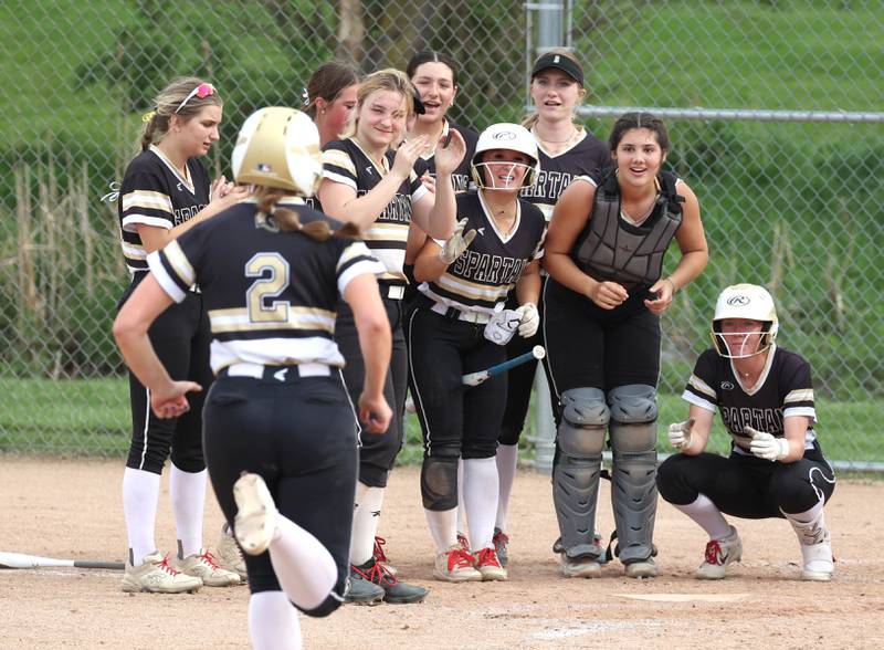 Sycamore's Brighton Snodgrass runs to her waiting teammates after she homered during their game against Ottawa Thursday, May 2, 2024, at Sycamore High School.