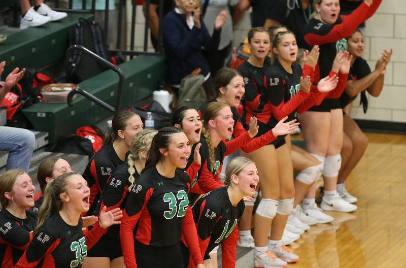 Members of the L-P volleyball team react after scoring a point against Princeton on Tuesday, Aug. 22, 2023 in Sellett Gymnasium.