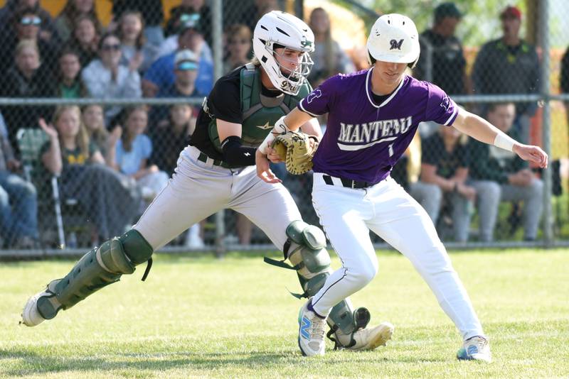 Bishop McNamara's Braylon Ricketts, left, tags Manteno's Andrew Norred out at home plate during the Class 2A Beecher Sectional semifinals Thursday, May 29, 2025.