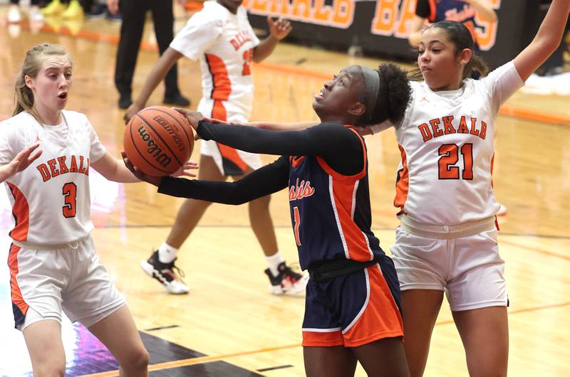 Naperville North's Natalie Frempong tries to score in front of two DeKalb defenders Monday, Jan. 22, 2024, during their game at DeKalb High School.