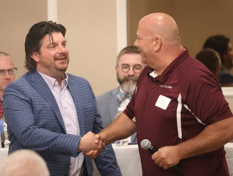 Illinois Valley Chamber of Commerce director Bill Zens shakes La Salle mayor Jeff Grove's hand after recieving a service award from the City of La Salle during the Illinois Valley Chamber of Commerce State of the Cities Luncheon on Thursday, April 23, 2026 at Grand Bear Lodge at Starved Rock in Utica.