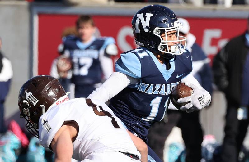 Nazareth's James Penley gets by Joliet Catholic's Nicholas Ronchetti on his way to a touchdown Saturday, Nov. 25, 2023, during their IHSA Class 5A state championship game in Hancock Stadium at Illinois State University in Normal.