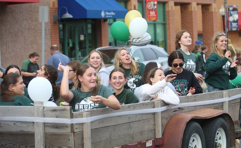 St. Bede volleyball players ride on a a float during the St. Bede Homecoming parade on Friday, Sept. 27, 2024 downtown Peru.