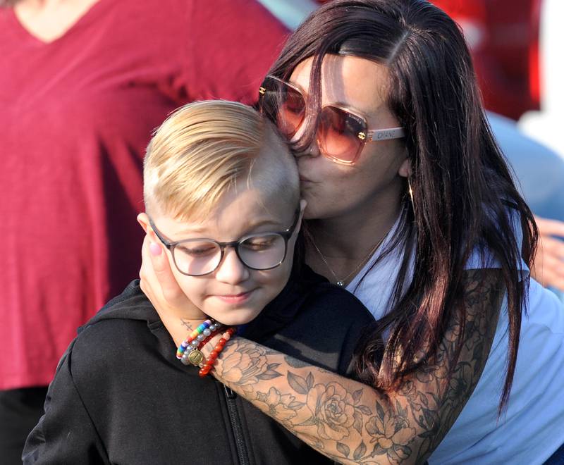 Third-grader Oliver Ohme gets a kiss on the cheek from his mom Hollie on the first day of school at Haskin Elementary in Sandwich on Wednesday, Aug. 17, 2023.