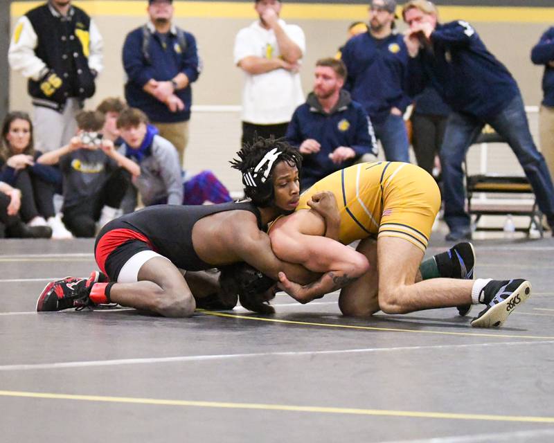 Yorkville Christian wrestler Aiden Larsen, left, keeps a hold of Rock Island wrestler Truth Vesey in the 113 weight class during the 2A Sectional meet on Saturday Feb. 10, 2024, held at Sycamore High School.