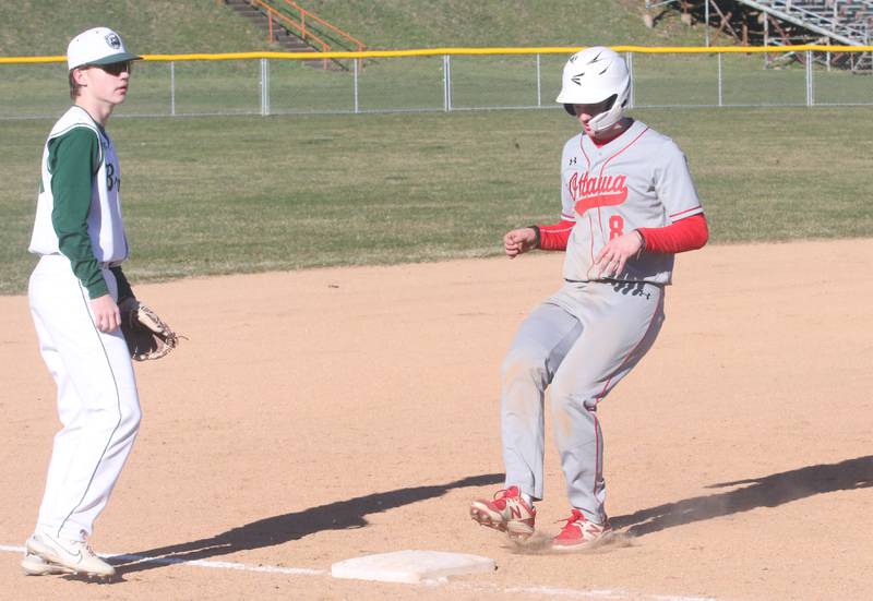 Ottawa's Garrett Shymanski reaches third base as St. Bede's Carson Riva watches the play on Wednesday, March 20, 2024 at St. Bede Academy.